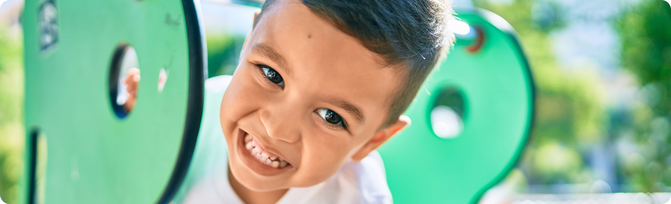 young boy smiling on playground