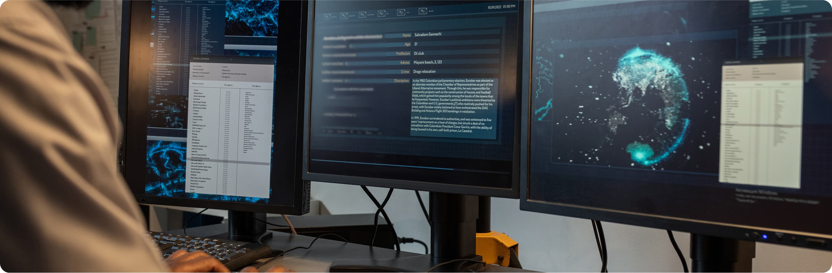 man behind a computer looking over data